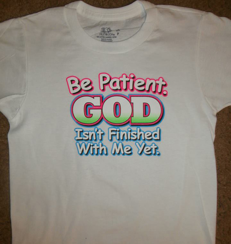 [Photo of a 'God Isn't Finished With Me Yet' tee shirt]