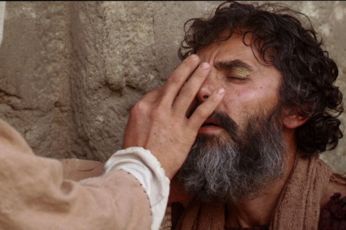 [Photo of Jesus healing a blind man]
