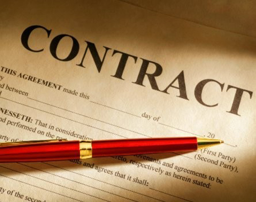 [Photo of a contract and a pen]