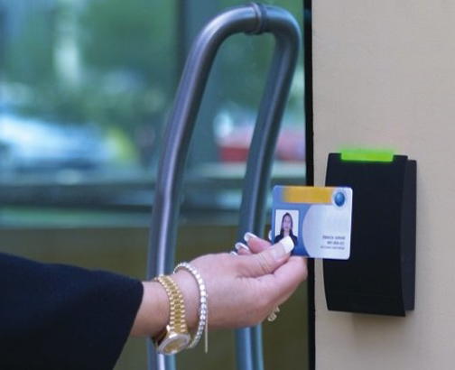 [Photo of a key card accessing an electronic door lock]