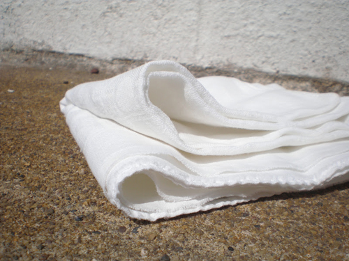 [Photo of a folded linen cloth laying on the ground]