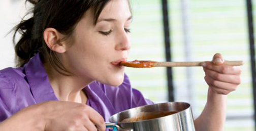 [Photo of a woman tasting a spoonful of soup]