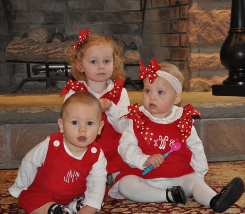 [Photo of three young children dressed in their Christmas clothing]