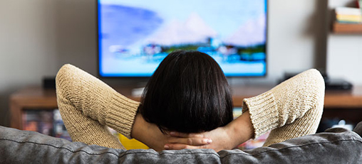 [Photo of a person watching TV]