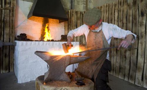 [Photo of a blacksmith at work]