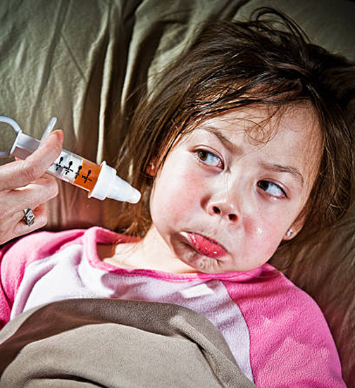 [Photo of a child refusing medicine]