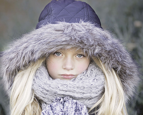 [Photo of a girl bundled up with a complacemnt look on her face]
