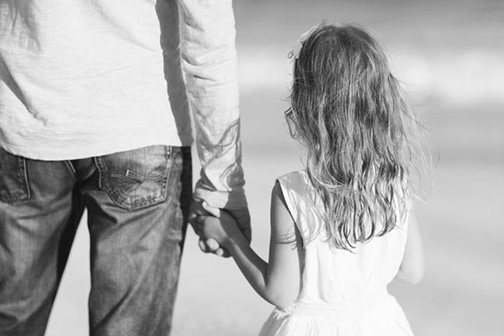 [Photo of a little girl holding her daddys hand]