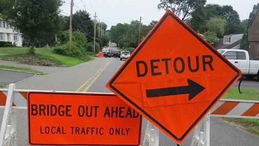 [Photo of bridge out and detour signs]