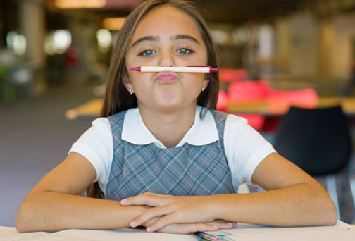 [Photo of a girls with a pencil balanced on her nose]