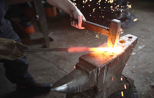 [Photo of a blacksmith at work]