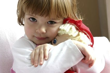 [Photo of little girl hugging her doll]