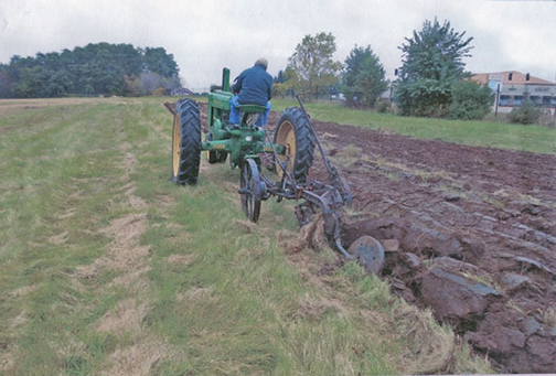 [Photo of tractor plowing a field]