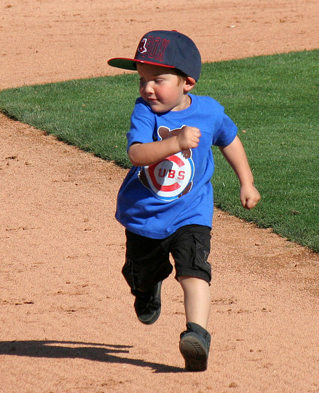 [Photo of a young boy running the bases]