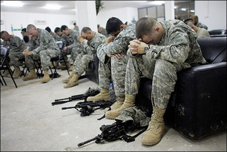 [Photo of soldiers praying]