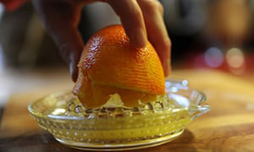 [Photo of squeezing an orange]