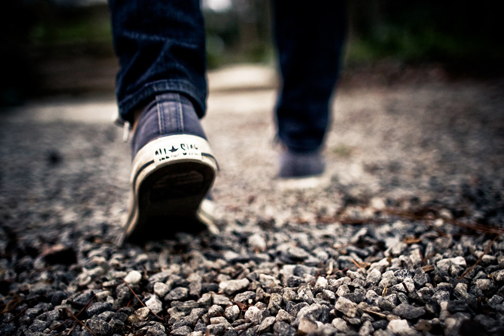[Photo of someone walking on gravel]