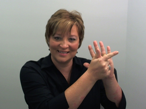 [Photo of a woman signing with American Sign Language]